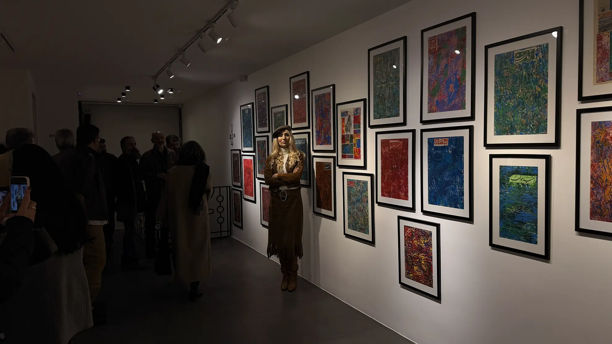 Visitors viewing a Matin House exhibition wall of curated works